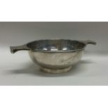 A heavy silver two handled porringer on pedestal f