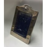 A rectangular silver picture frame with chased dec