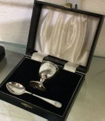 A cased silver egg cup together with matching spoo
