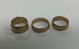 A group of three heavy 9 carat wedding bands. Appr