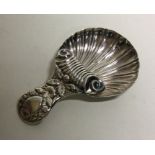 A silver caddy spoon with scroll hood over bowl. B