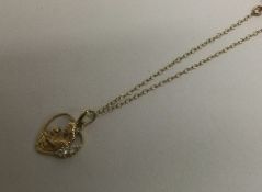 A 9 carat heart shaped pendant on fine link chain