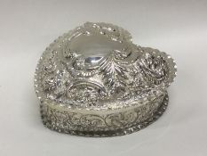 A heavy chased Victorian silver box embossed with