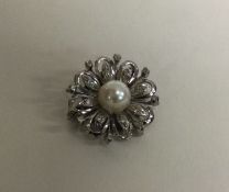 An attractive pearl and diamond brooch of circular