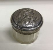 A heavy silver mounted glass box with chased decor