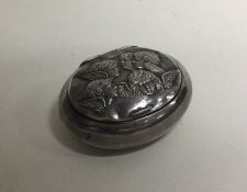 A novelty silver hinged box with chased cherub dec