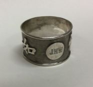 A Chinese export silver napkin ring chased with Ch