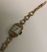 A 9 carat wristwatch on expandable strap. Approx.