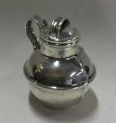 A circular silver pepper in the form of a jersey c