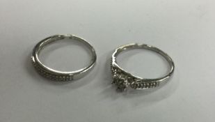 Two 9 carat diamond mounted rings. Approx. 3.4 gra