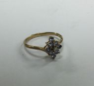 A 9 carat three row cluster ring. Approx. 2 grams.