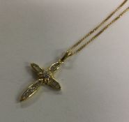 An attractive diamond mounted cross in 18 carat go