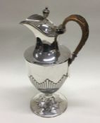 A good silver half fluted ewer with wicker handle.