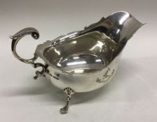 A crested silver Georgian style silver sauce boat.