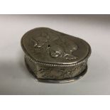 A heart shaped silver dressing table box decorated