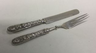 A cast Chinese silver two piece christening set de