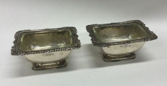 A pair of silver mounted glass salts with shell bo