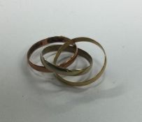 A 9 carat three coloured gold triple wedding band.