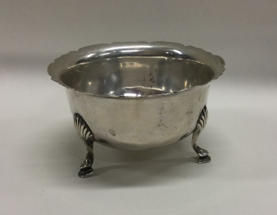 A heavy silver sugar bowl with card cut rim. Londo