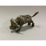 A silver figure of an ox with textured body. Appro