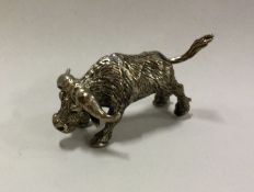A silver figure of an ox with textured body. Appro