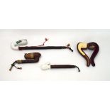 A group of four pipes including a cased Salmon & Gluckstein Ltd.