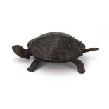 A cast metal desktop bell modelled as a tortoise,