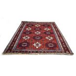An Indian rug with a red and blue ground,