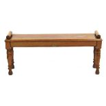An early 20th century mahogany window seat on turned legs,