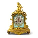 A 19th century French mantel clock, the porcelain panel with Roman numerals,