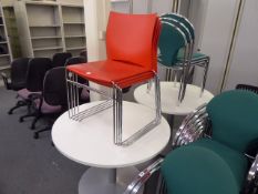 100cm diameter meeting table with a stack of 4 chrome and red plastic Task stacking chairs
