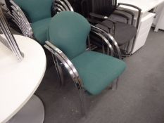 8 chrome stacking chairs with green cloth backs and seat