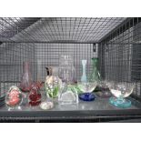 Cage containing paperweights and glass vases