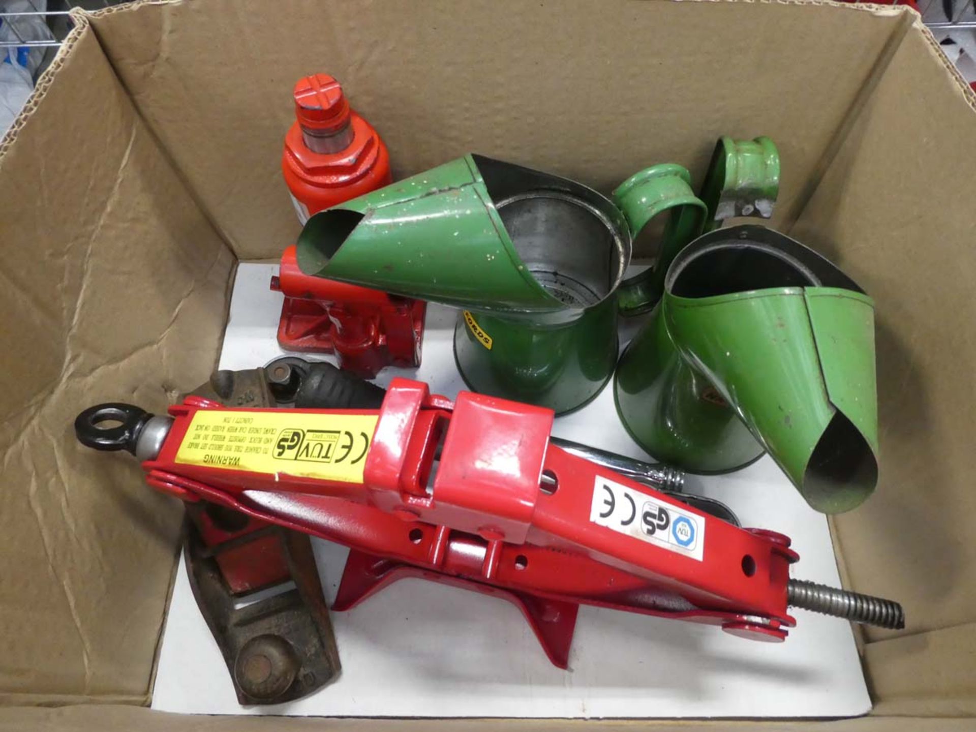 Cardboard box containing two jacks, two oil pans and a small plane