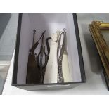 Box containing a quantity of button hooks and a shoe horn