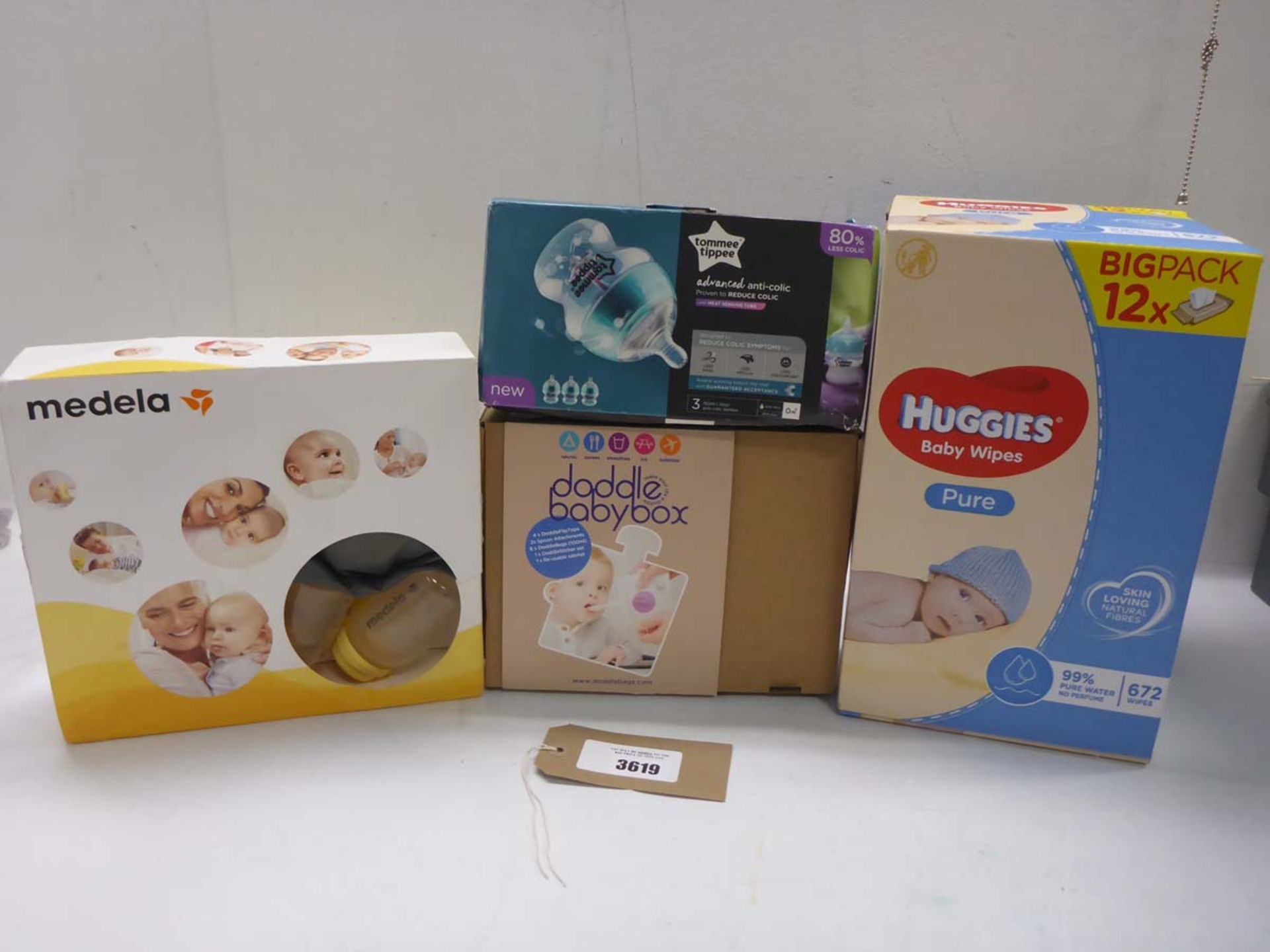 Medela breast pump pack, Tomme Tippee feeding bottles, Dobble babybox set and Box of 672 Huggies