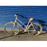 Cream painted over maroon ladies push bike