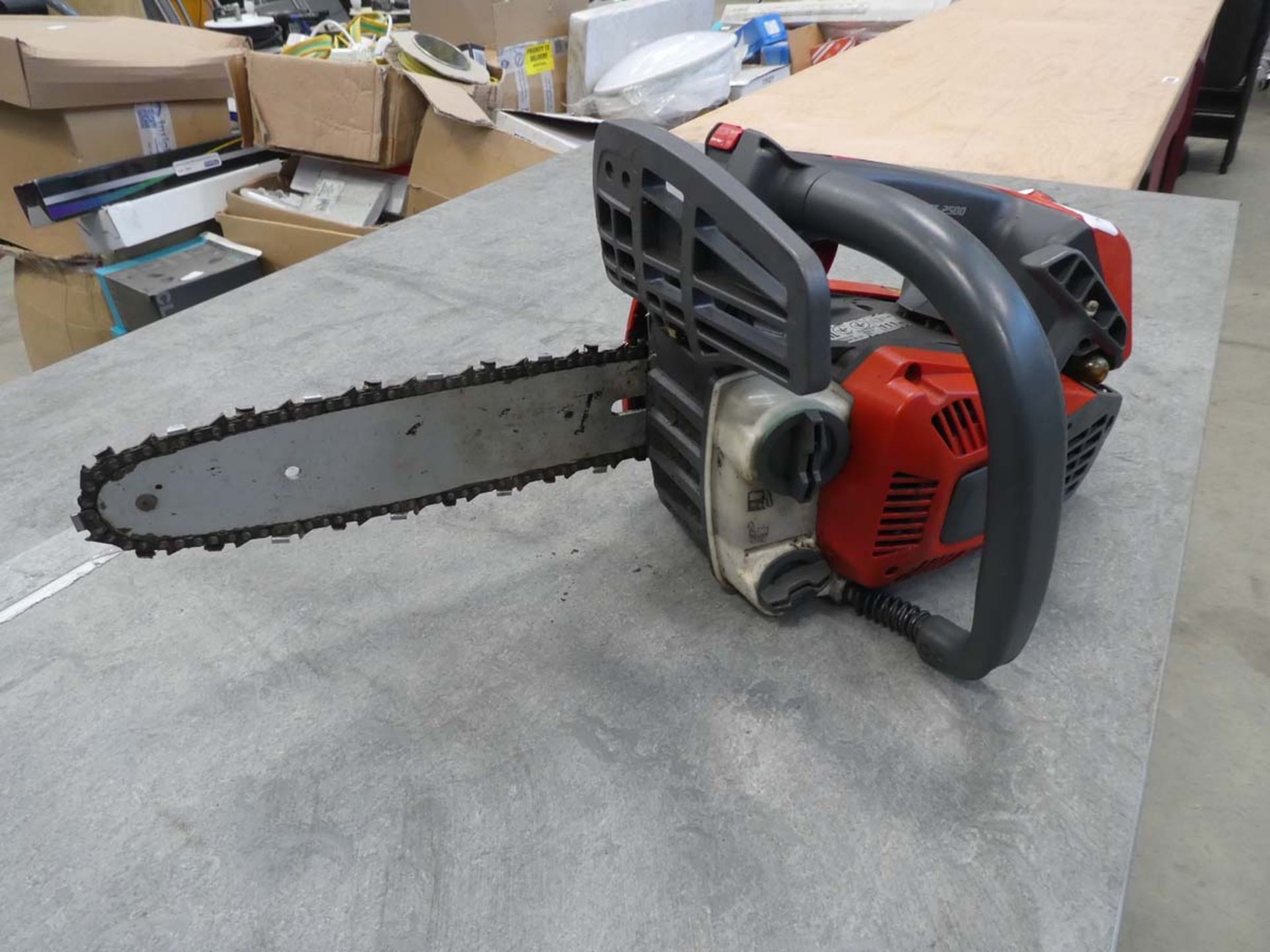 Small red Echo petrol powered chainsaw