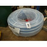 Coil of clear plastic hose