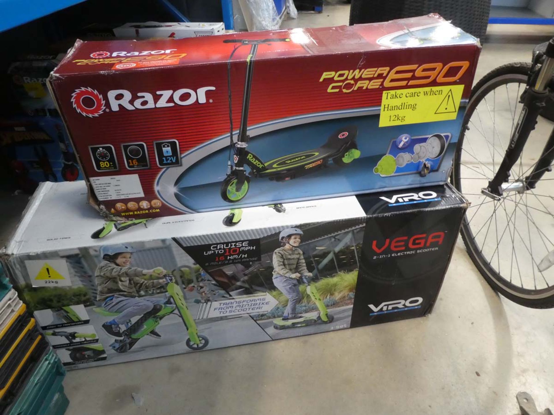 Vega boxed electric scooter and a Razor boxed electric scooter