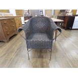 Wicker garden chair on bent metal supports