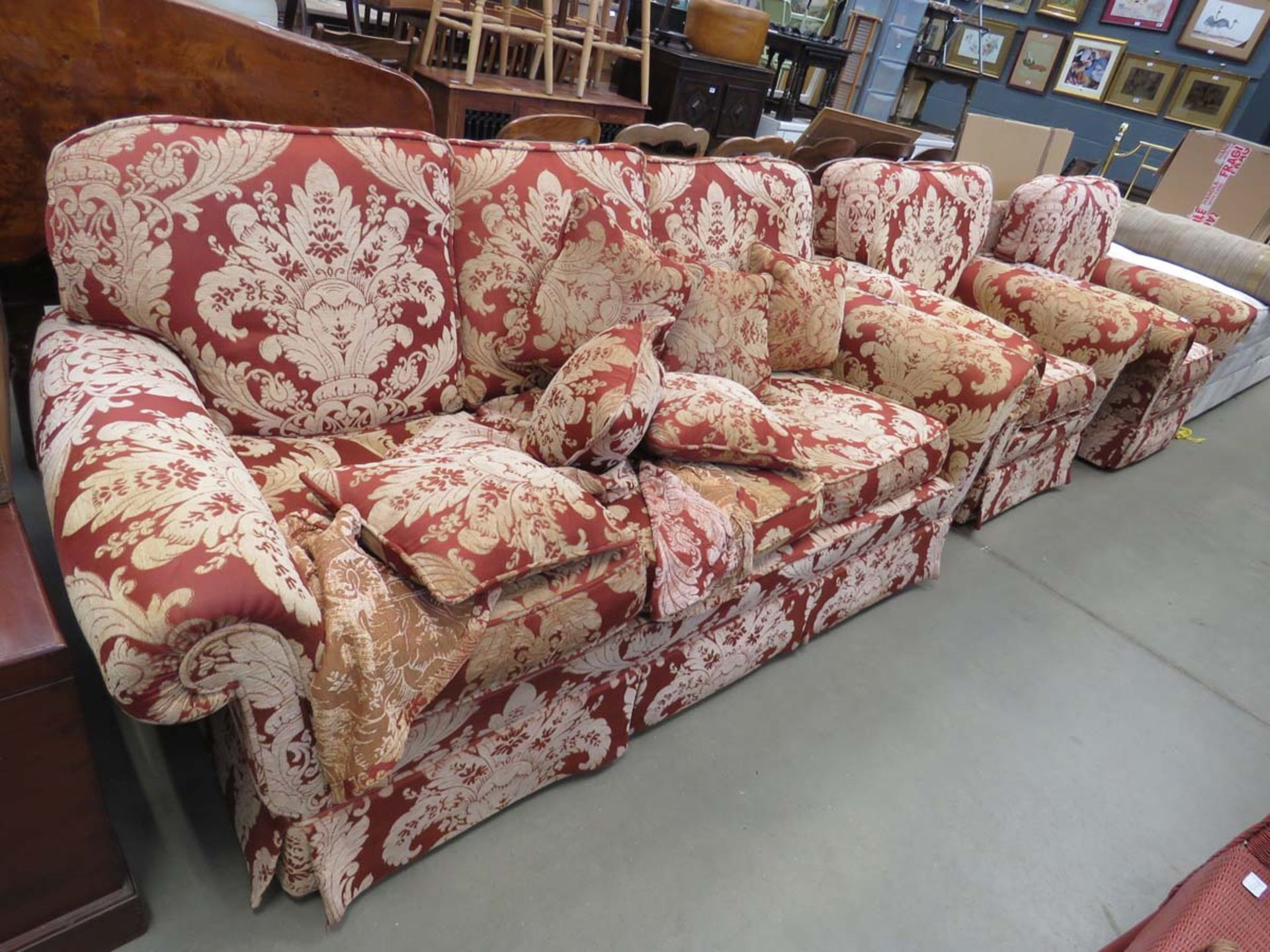 A maroon and floral patterned Peter Guild 3 seater sofa and a pair of matching armchairs