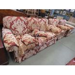 A maroon and floral patterned Peter Guild 3 seater sofa and a pair of matching armchairs