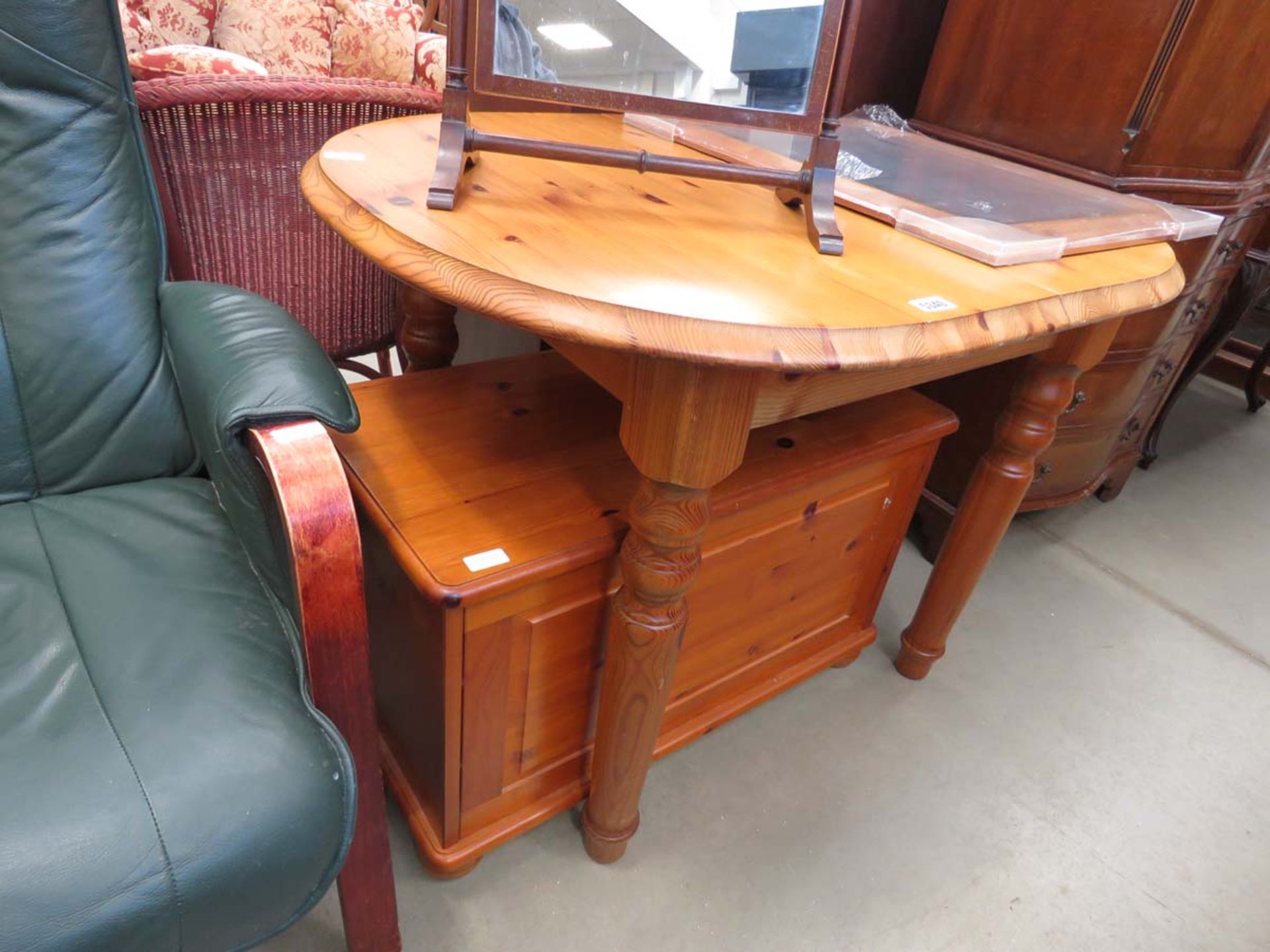 Pine extending table with a modern blanket box and a mirror