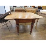 Oak drop leaf table on turn supports