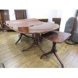 Oval dark wood extending dining table on tripod support with matching single occasional table on