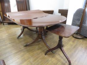 Oval dark wood extending dining table on tripod support with matching single occasional table on