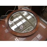 Circular bevelled mirror in oak frame