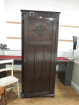 Single door oak wardrobe with carved panel on top