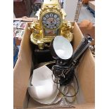 Box containing motor engineering books, crockery, adjustable desk lamp and a modern French clock